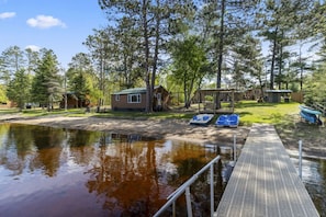 A lakeside cabin with a dock, paddle boats, and a small boat house. - Perfect Lake Escape | Sleeps 14 | Water views! (Emily)