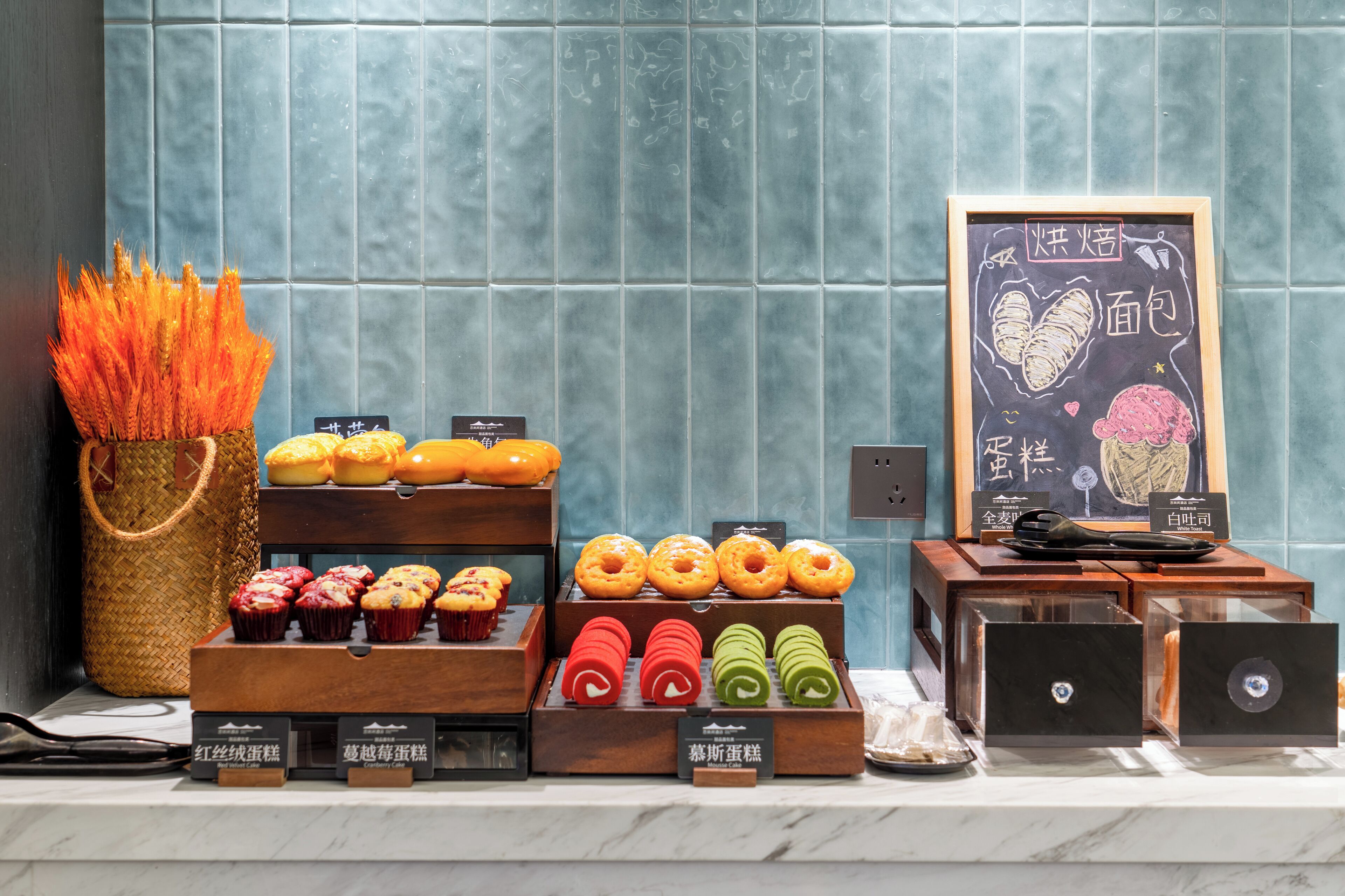 A bakery display with various baked goods and a chalkboard menu.
