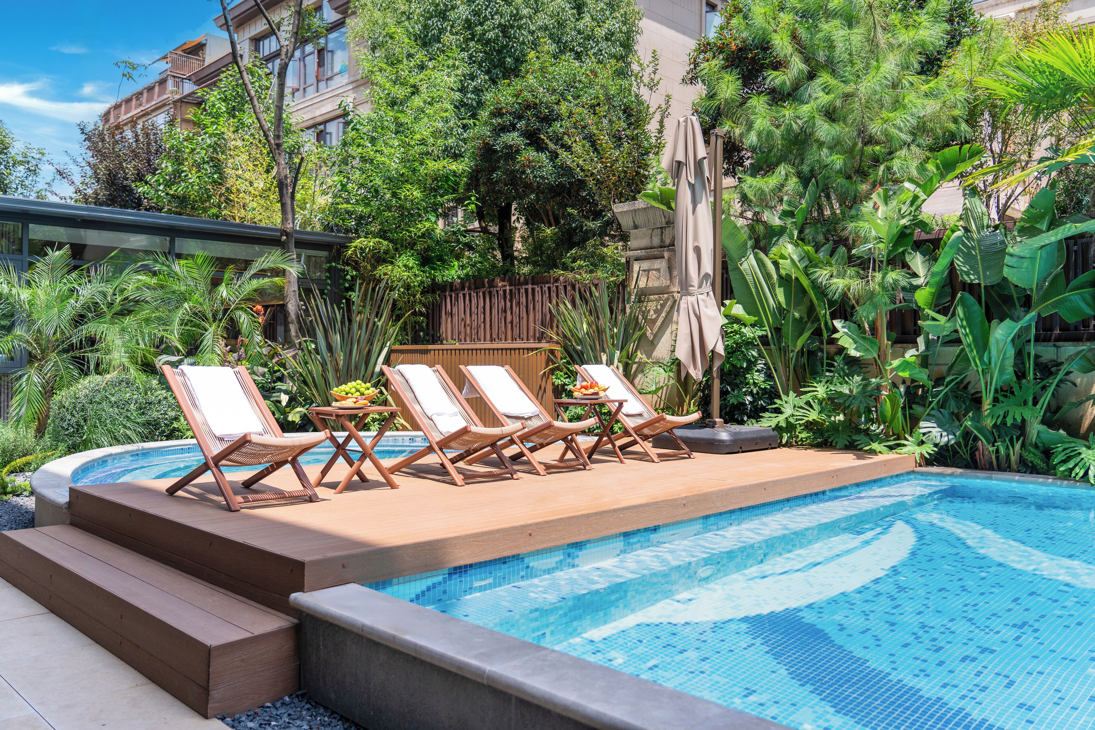 Seasonal outdoor pool, open 10:00 AM to 6:00 PM, pool umbrellas