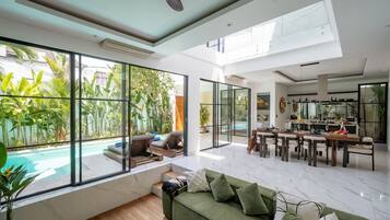 Deluxe Villa, 3 Bedrooms, Pool View | Living room | 55-inch TV with cable channels