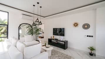 Deluxe Villa, 3 Bedrooms, Pool View | Living room | 55-inch TV with cable channels