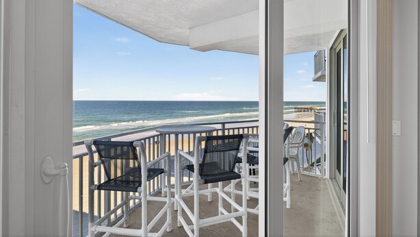 A balcony with a view of the beach and ocean. - Coastal Daydream At White Surf (Daytona Beach)
