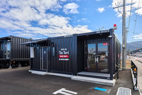 A modern hotel named "The Yard" with a front desk, located near a railway station.
