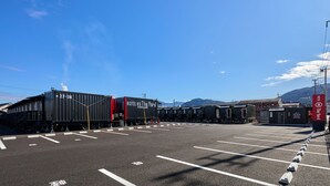 Uma estação de trem com vários vagões e um prédio com a placa 