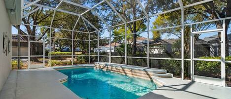A covered swimming pool with a clear view of the surrounding neighborhood.