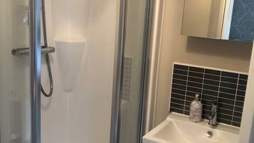 Shower, towels, soap, toilet paper