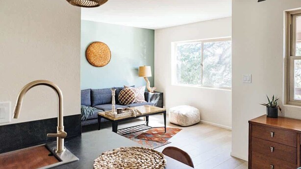 A modern kitchen with a sink, dining table, and a cozy seating area with a sofa and a lamp. - Modern and Relaxing Sedona Oasis - Bedouinn (Sedona)