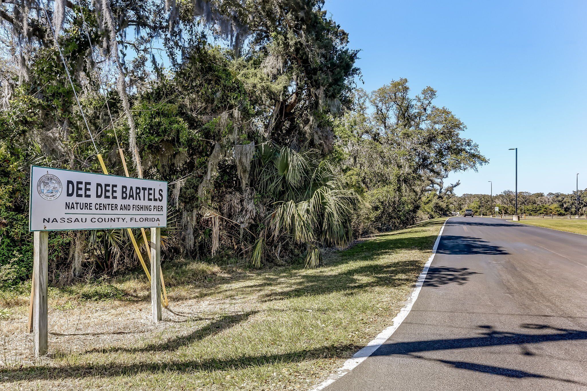 A road sign for Dee Dee Bartels Nature Center and Fishing Pier in Nassau County, Florida.