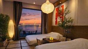 A hotel room with two beds, a balcony with a view of a bridge, a hanging lamp, and a Japanese-style painting. - SainTree Hotel (Incheon)