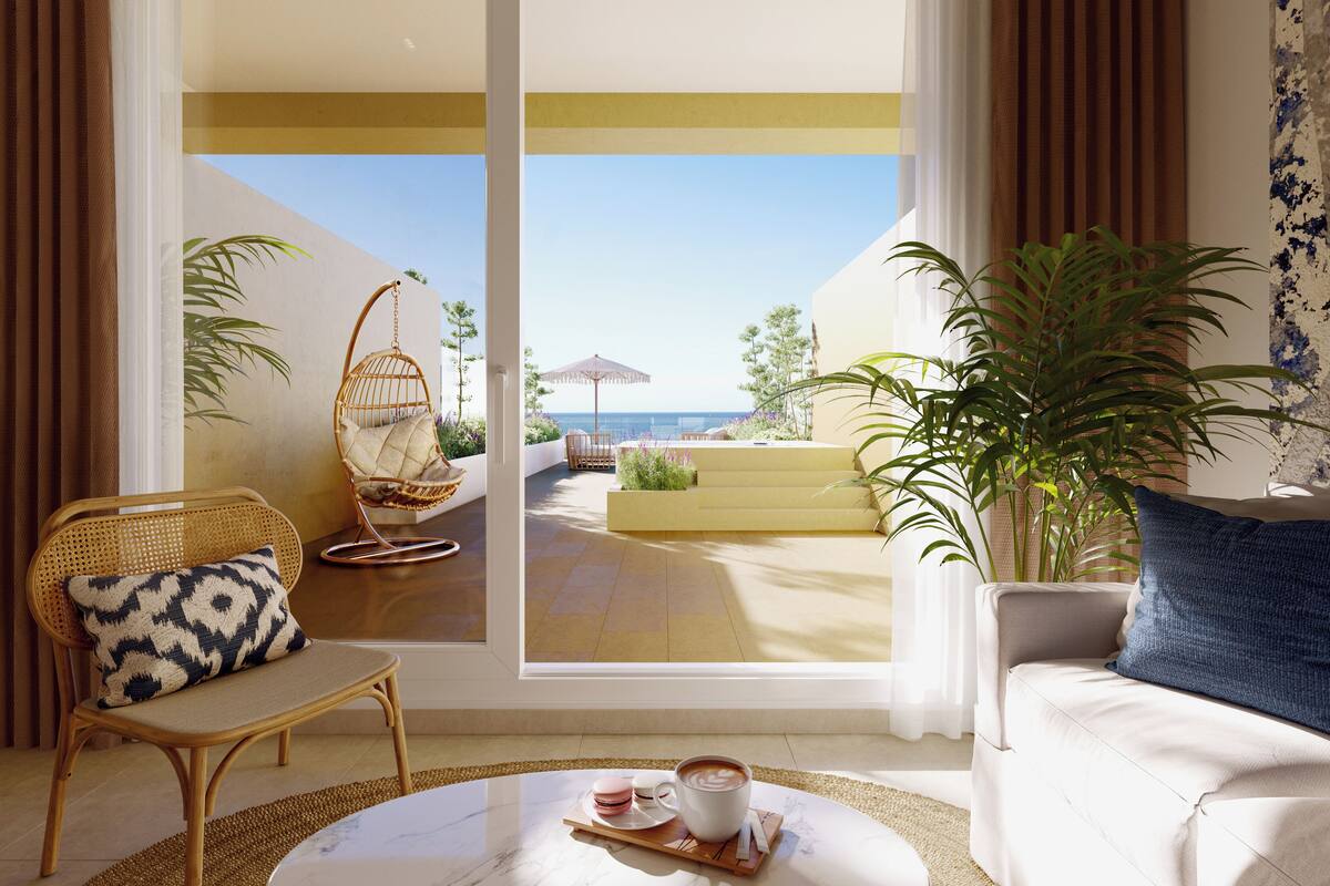 A modern living room with a view of the sea, a hanging chair, a sofa, and a dining area with a table set for two.