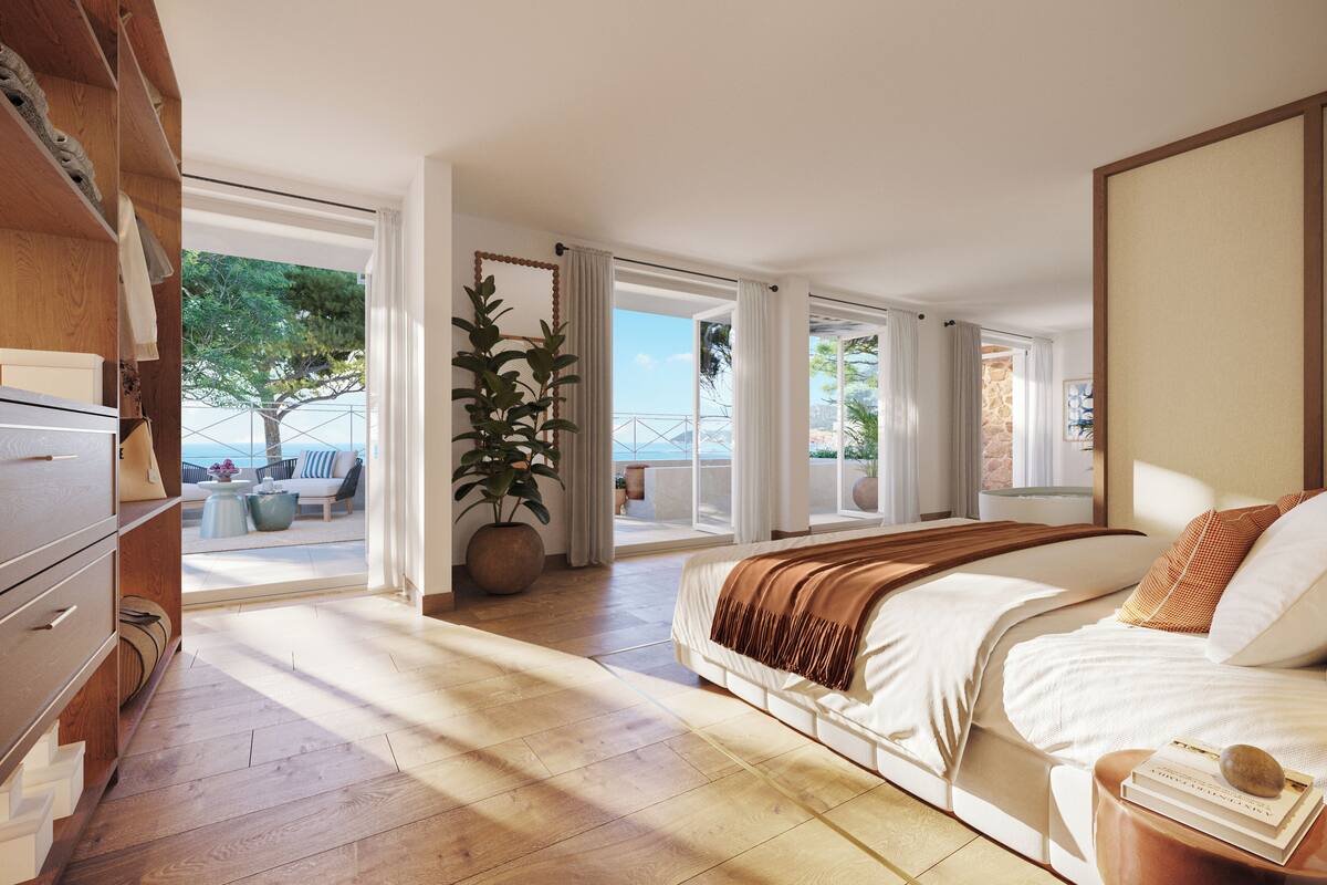 A spacious bedroom with a large bed, a wooden dresser, and a view of the outdoor balcony area.