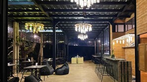 An indoor dining area with tables and chairs, a bar counter, and hanging light fixtures. - Waraka - Udawalawe By Thema Collection (Udawalawa)