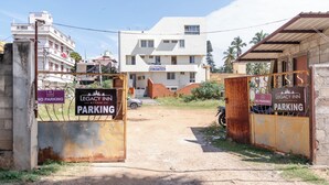 A gated entrance to a building with signs indicating no parking and parking areas. - Legacy Inn, Mysore (Mysore)