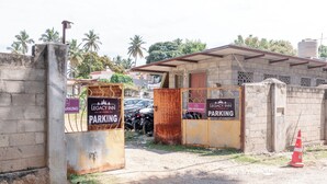 A gated entrance to a building with signs indicating parking areas. - Legacy Inn, Mysore (Mysore)
