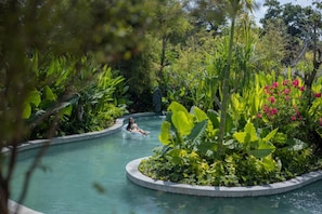A pool surrounded by lush greenery and tropical plants. - Sumitra Luxury Villas And Resort (Denpasar)