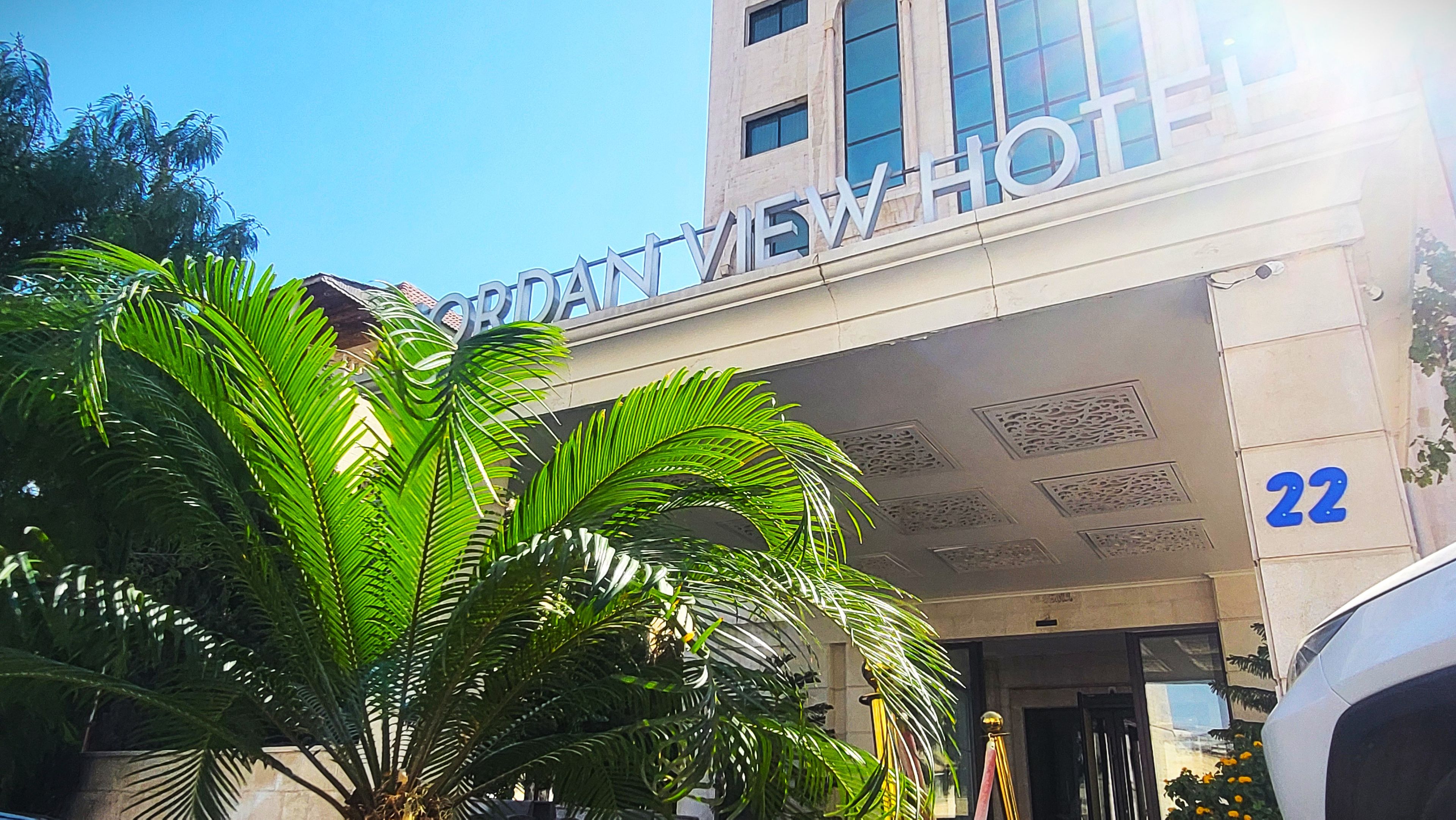 A hotel entrance with a sign reading "CROWNVIEW HOTEL" and the number "22" on the building.