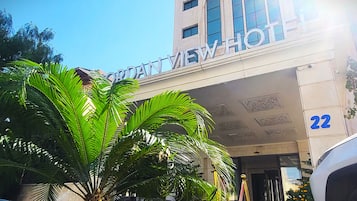 A hotel entrance with a sign reading "CROWNVIEW HOTEL" and the number "22" on the building.
