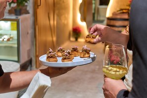 A person holding a plate with food and a glass of wine. - Casa Maria Hotel Vallarta (Puerto Vallarta)