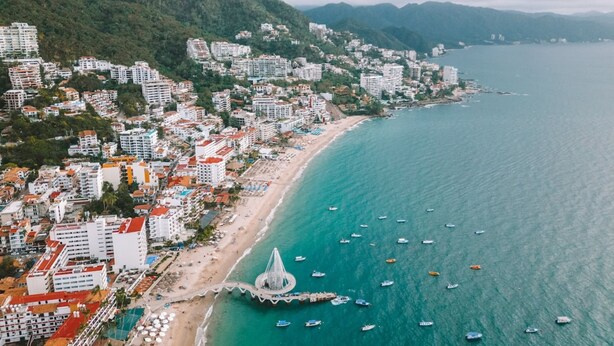 A coastal cityscape with buildings, a beach, and boats. - Casa Maria Hotel Vallarta (Puerto Vallarta)