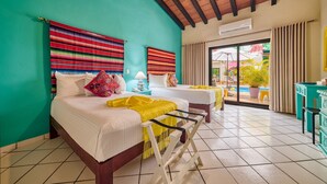 A room with two beds, a ceiling fan, a window with curtains, and a view of the outside. - Casa Maria Hotel Vallarta (Puerto Vallarta)