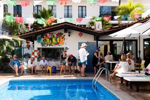 A pool area with a tiled floor, a lifebuoy, and a colorful mural on the wall. - Casa Maria Hotel Vallarta (Puerto Vallarta)