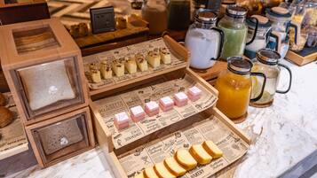 A bakery display with various baked goods and beverages.