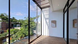 Un intérieur moderne avec de grandes fenêtres en verre, un plancher en bois et un décor minimaliste.