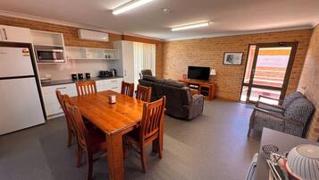 A compact living space with a kitchen, dining area, and seating area.