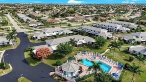 A residential area with a swimming pool and a clubhouse. - San marco villas 2-bedroom newly updated condo in lovely Marco Island  (Marco Island)