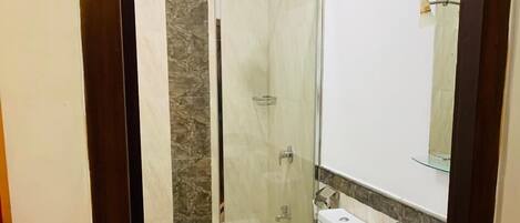 Un baño con inodoro, lavamanos y ducha.