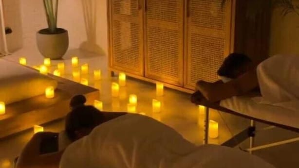 A room with a bed, a wooden cabinet, and several candles. - Deergayu Homestay  (Mirissa)