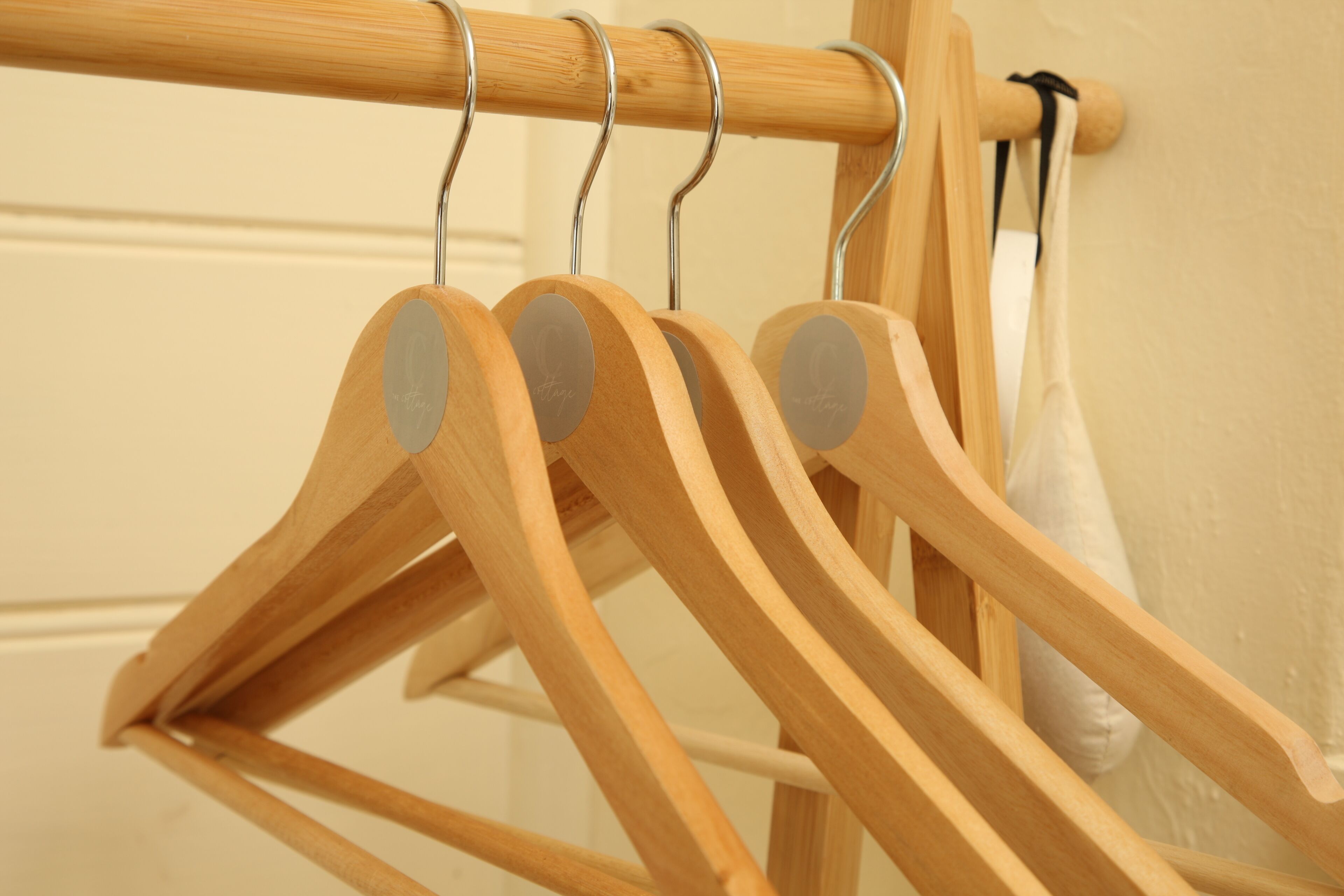 Wooden hangers on a metal rack.