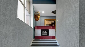 A staircase with a reception desk labeled "Collection" and "Company Serviced." - Collection O Bhel Piplani Bhopal (Bhopal)