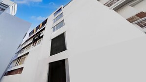 A modern building with multiple floors, balconies, and large windows. - Townhouse Railway Road Katrathe Amro (Reasi)