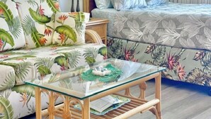 A room with a bed, a sofa, a glass-top table, and a lamp. - Island-Inspired Cozy Retreat - Free WIFI (Honolulu)