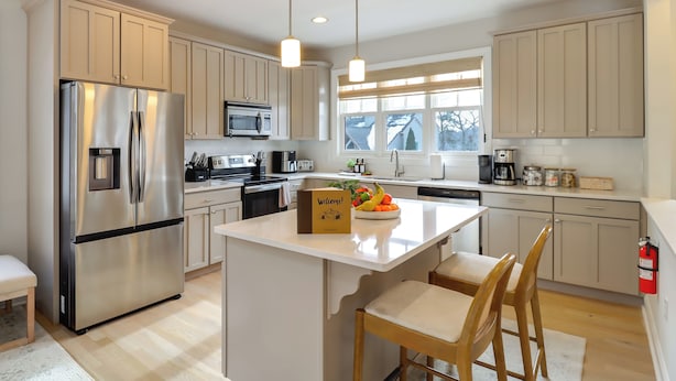 A modern kitchen with a central island, stainless steel appliances, and light wood cabinetry. - Walk to Big Boulder Mtn & Lake, Home w/ Hot Tub! (Lake Harmony)
