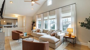 A modern living room with a sectional sofa, a coffee table, and a TV mounted on the wall. - Walk to Big Boulder Mtn & Lake, Home w/ Hot Tub! (Lake Harmony)