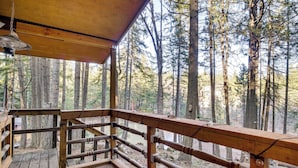 A wooden deck with a railing overlooking a forested area. - Fire Pit & Water Views! Woodsy Tygh Valley Retreat (Tygh Valley)