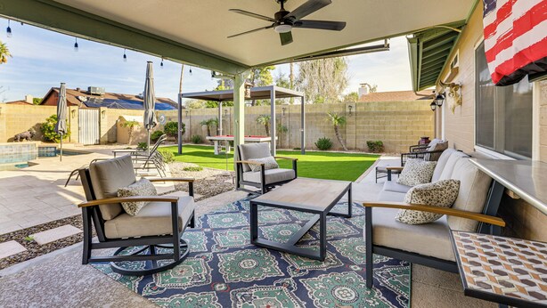 An outdoor patio area with a ceiling fan, a patterned rug, and outdoor furniture including a sofa and chairs. - Private Outdoor Oasis! Chandler Home, 5 Mi to Dtwn (Chandler)