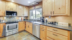 A kitchen with wooden cabinets, stainless steel appliances, and a granite countertop. - Private Outdoor Oasis! Chandler Home, 5 Mi to Dtwn (Chandler)