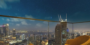 A high-rise building with a starry night sky view from a balcony. - LUX | 47th Floor | Panoramic View | 2BR | Downtown (Dubai)