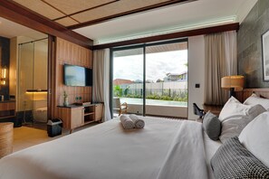 A hotel room with a large bed, a TV, a desk, and a view of the outdoors. - Villa Pasisi 11 - Canggu (Canggu)