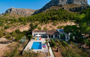 A villa with a swimming pool, outdoor seating, and a view of a mountainous landscape. - Beautiful home in Colonia de Sant Pere (Colonia de Sant Pere)