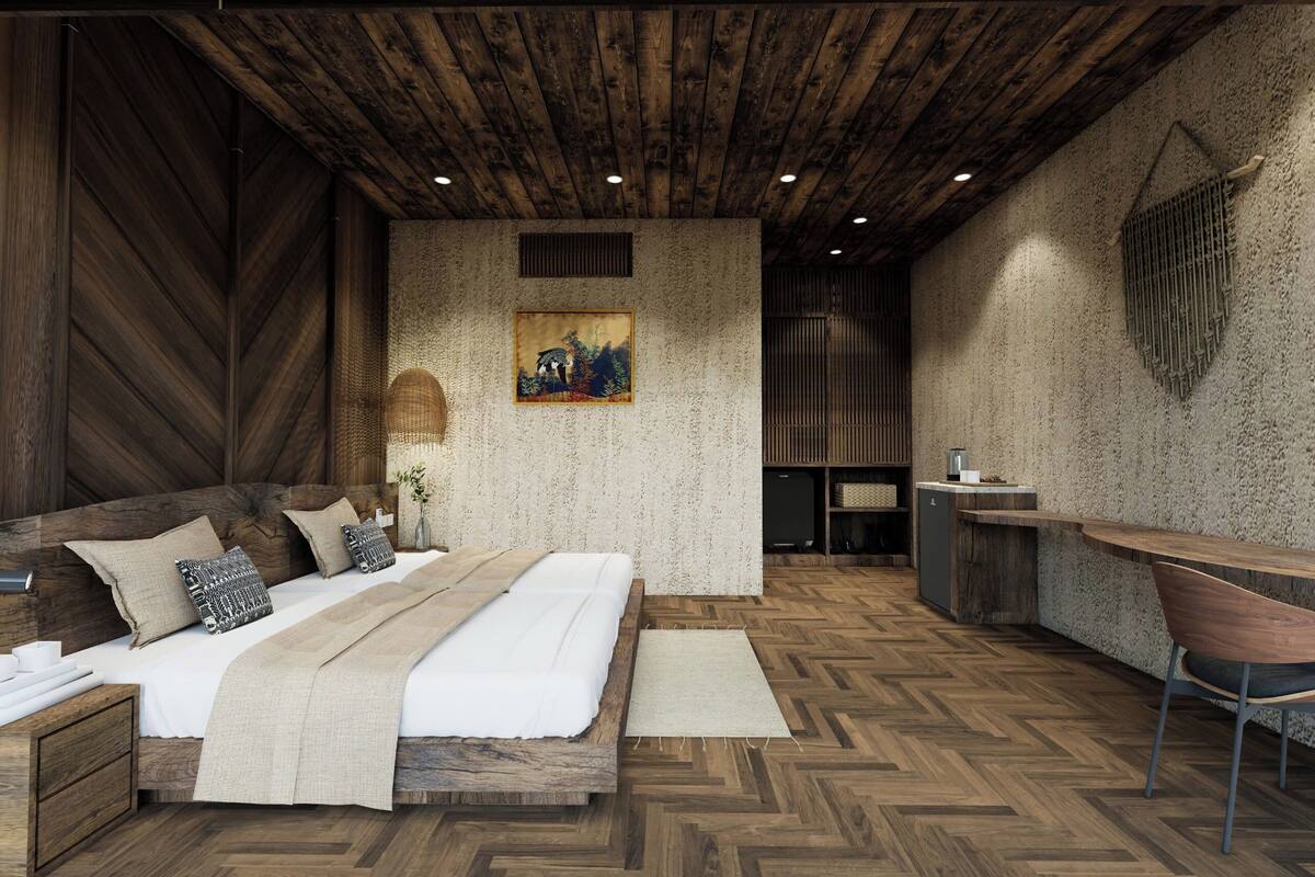 A modern bedroom with a wooden ceiling, a large bed, a desk, and a chair.