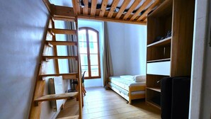 A small, well-lit room with a wooden ladder, a bed, and a built-in wardrobe. - Big flat - Le Cala - City Center (Nice)
