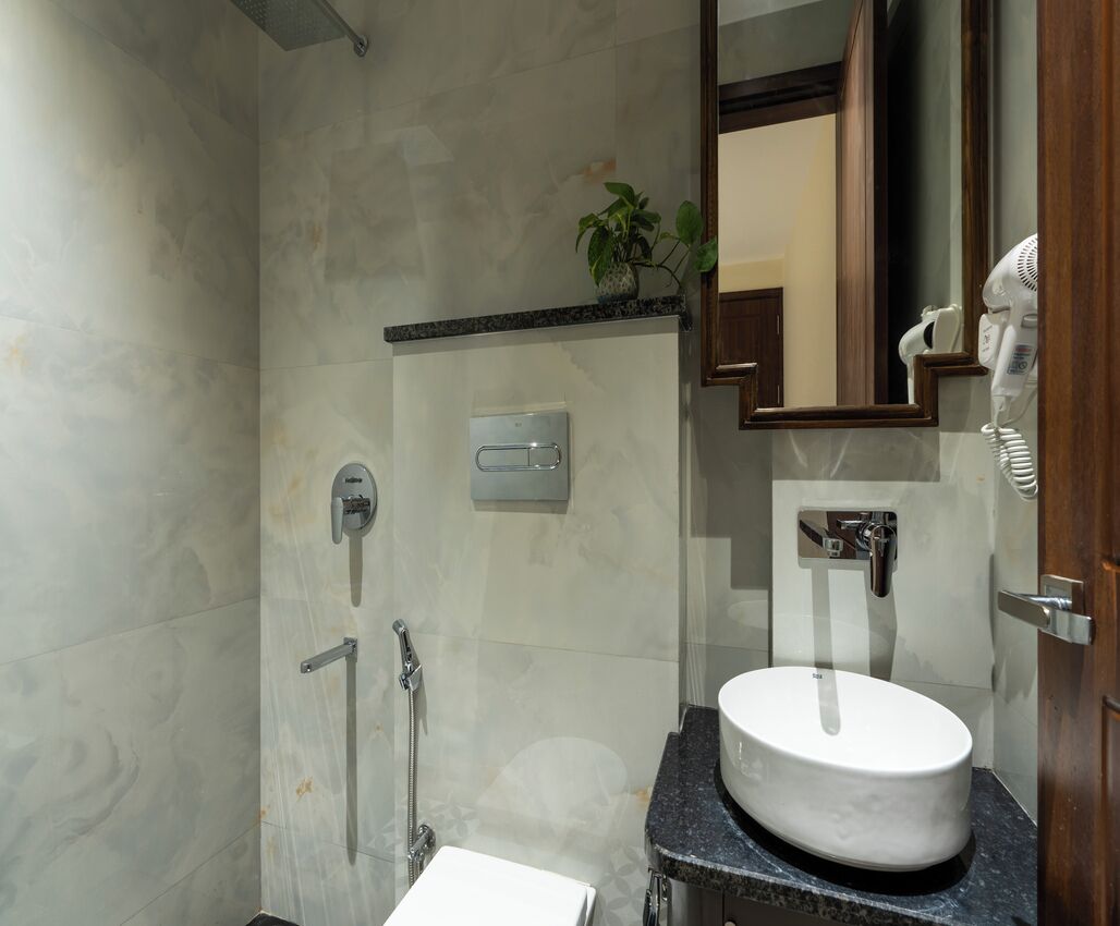 A modern bathroom with a shower, a sink, and a mirror.