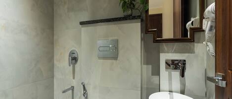 A modern bathroom with a shower, a sink, and a mirror.