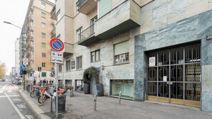 A street with buildings, a no parking sign, and a bicycle parking area. - GuestHost - A modern and spacious 142 square meters apartment, perfect for five people, located on the second floor of a building with an elevator (NOT accessible to guests with disabilities).The property is just steps from the S. Agostino metro station, (Milan)