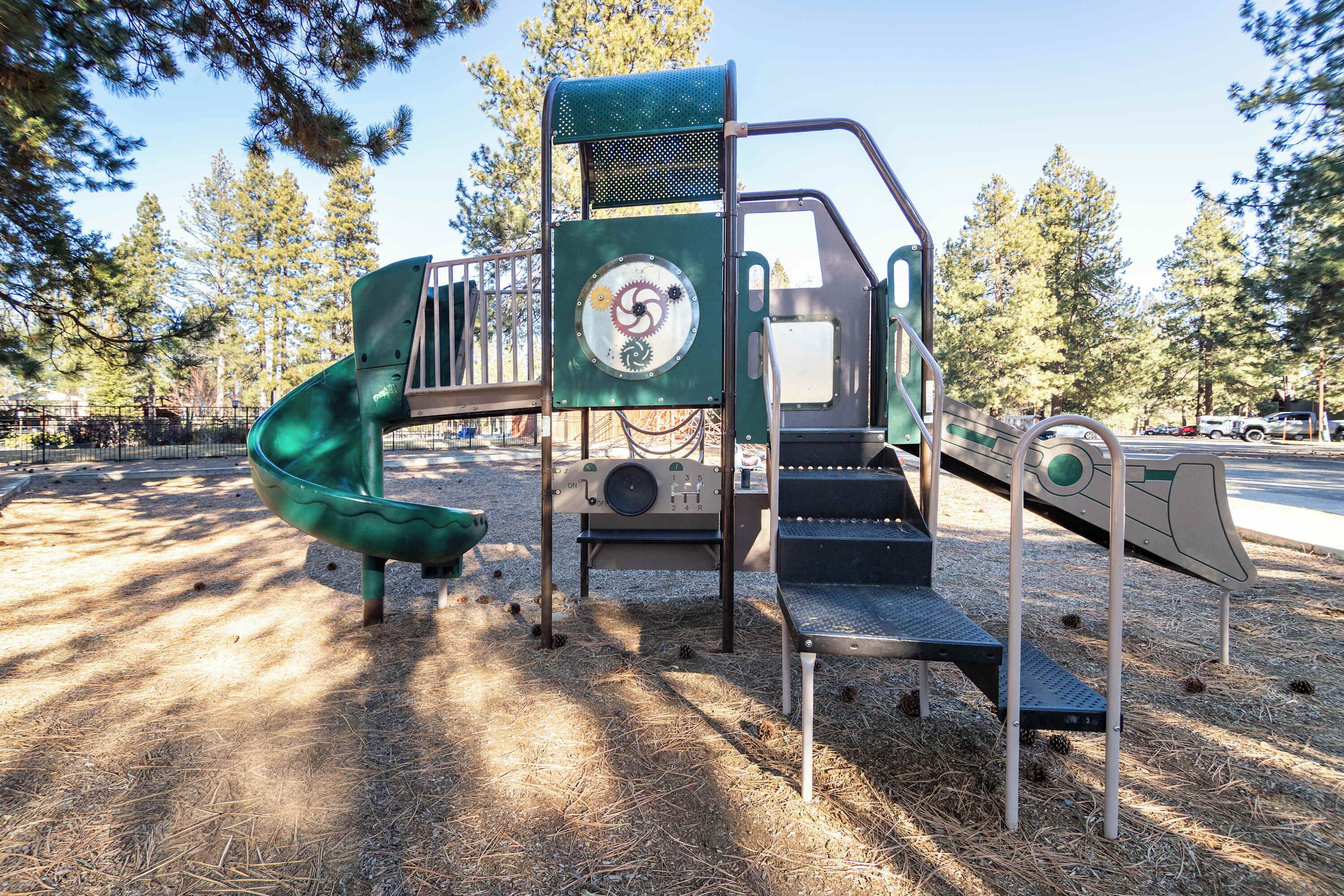 A playground with a slide, steps, and a climbing structure.