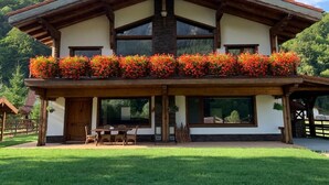 A two-story house with a balcony, large windows, and a wooden roof. - Avalanche (Zarnesti)